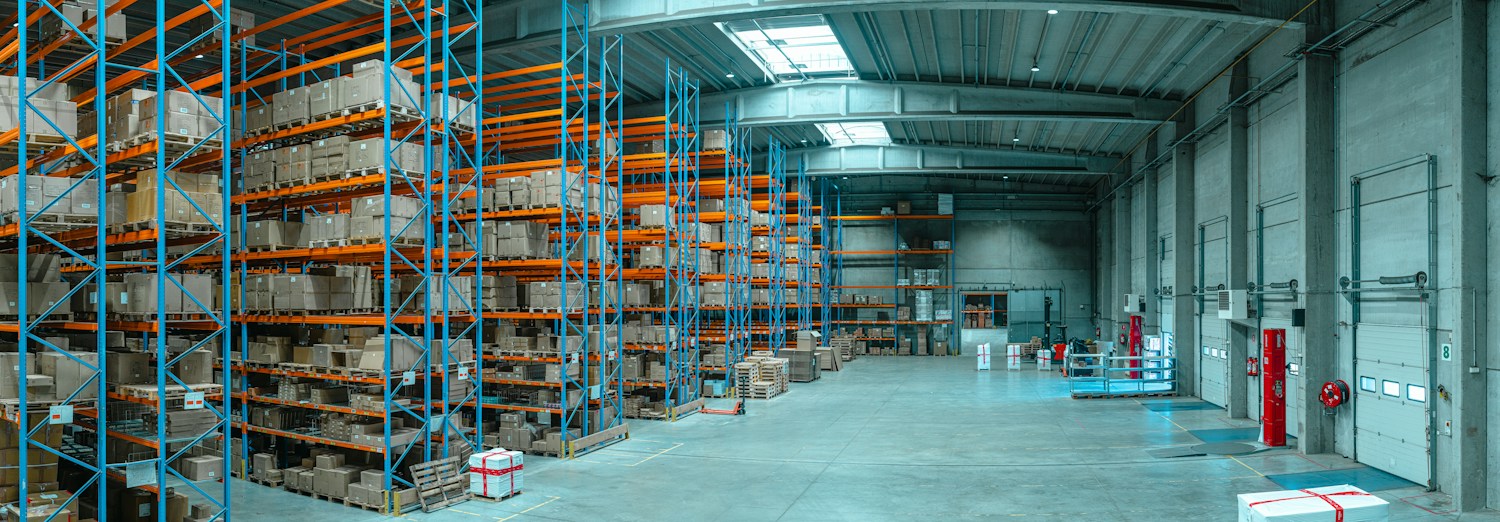 Cardboard boxes stacked on tall warehouse shelving